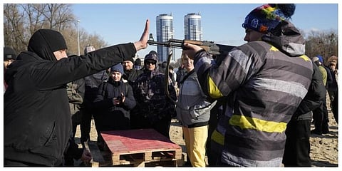 An instructor shows how to use a Kalashnikov assault rifle as members of a Ukrainian far-right group train in Kyiv, Ukraine, Sunday.