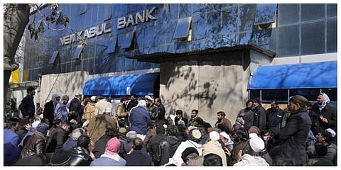 People wait to enter a bank in Kabul on Sunday, February 13, 2022. (Photo: AP)
