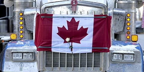 A Canadian flag tied to the hood of a semi-trailer truck, on the 18th day of a protest against COVID-19 measures that has grown into a broader anti-government protest.(Photo | AP)