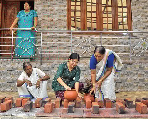 A family residing near Attukal Devi temple in Thiruvananthapuram making arrangements in front of their home on the eve of Pongala | B P Deepu