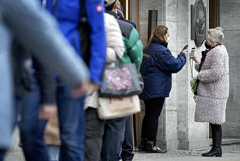 People present their vaccination status as they queue in front of the famous department store 'KaDeWe' (Department Store Of The West) in Berlin. (Photo | AP)