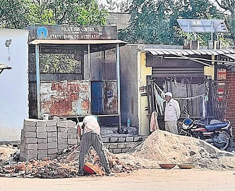 Construction work goes on at the police outpost in front of the Sirpur Kagaznagar bus stand in Kumrambheem-Asifabad district on Wednesday.
