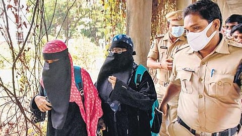 Police escort the two Muslim girls wearing burqa to their classroom at Andhra Loyola College in Vijayawada on Thursday. (Photo | Prasant Madugula)