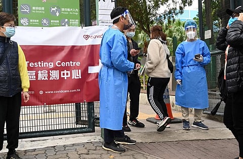 People enter a Covid-19 testing centre in Hong Kong on February 18, 2022, as the city faces its worst Covid-19 outbreak since the start of the pandemic. (AFP)