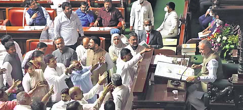 Congress members stage a protest demanding dismissal of Minister KS Eshwarappa, in the Assembly on Friday