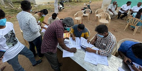 Polling station officials and the political party representatives who had set up their camps helped the voters identify their polling stations with their EPIC numbers. (Photo | EPS)