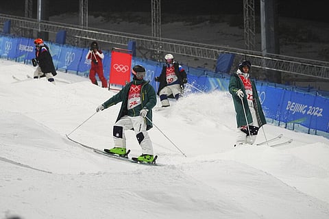 Australia's Matt Graham (25) and James Matheson (22) inspect the moguls course before a training session ahead of the 2022 Winter Olympics. (Photo | AP)