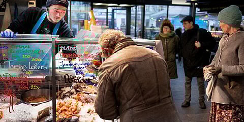 FILE - Customers at the fish market in Torvehallerne in Copenhagen, Denmark, Tuesday, Feb. 1, 2022. (Photo | AP)