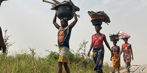 Women and children return from their farmlands after the day's work in Agatu village on the outskirts of Benue State in northcentral Nigeria, Wednesday, Jan 5, 2022. (Photo | AP)