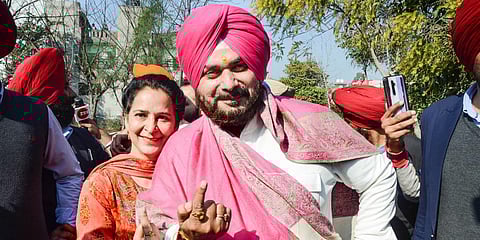 Punjab Congress chief Navjot Singh Sidhu and his wife Navjot Kaur show their inked fingers after casting votes for Punjab Assembly elections, near Amritsar. (Photo | PTI)