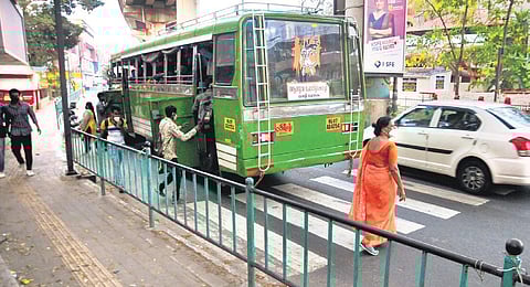 An elderly woman tries to cross the road through a zebra crossing at Changampuzha Nagar on Sunday |(Photo| EPS, A Sanesh)