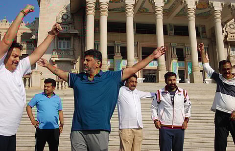 Congress legislators, including KPCC chief DK Shivakumar, exercise outside Vidhana Soudha in Bengaluru on Sunday (Photo| Nagaraja Gadekal, EPS)