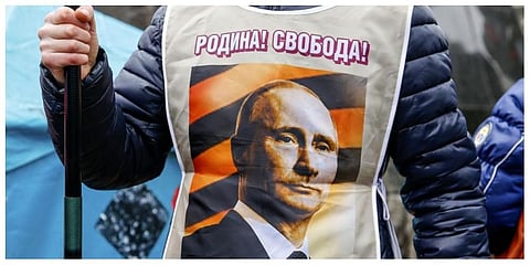 A pro-Russia demonstrator wears a vest bearing a depiction of Russian President Vladimir Putin and the words, 'Motherland! Freedom!' during a rally in Donetsk, Ukraine on March 16, 2014. (Photo: AP)