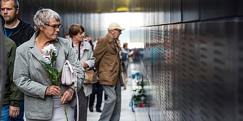 People gather at The Memorial of Victims of Communism to mark the European Day of Remembrance for Victims of Stalinism and Nazism, also known as Black Ribbon Day, in Tallinn, Estonia. (Photo | AP)
