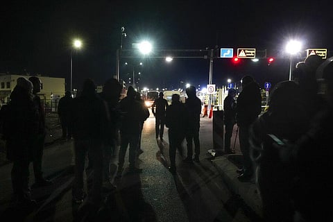 People wait for members of their family fleeing the conflict from neighboring Ukraine at the border crossing in Medyka, southeastern Poland. (Photo | AP)