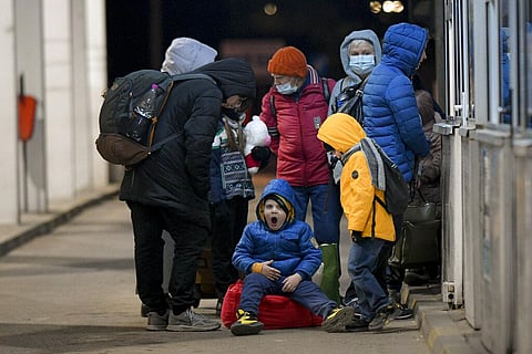 A child from Ukraine yawns as he waits to gain entry into Romania at the Romanian-Ukrainian border, in Siret, Romania. (Photo | AP)