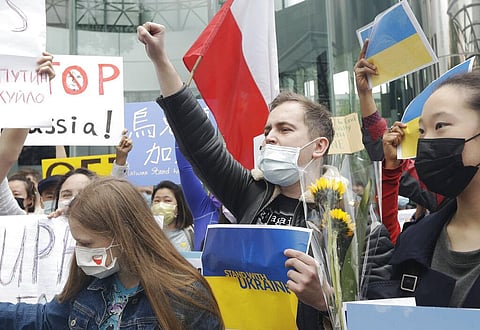 A group of Ukrainian people in Taiwan and supporters hold posters and shout slogans to protest against the invasion of Russia in solidarity with the Ukrainian people. (Photo | AP)