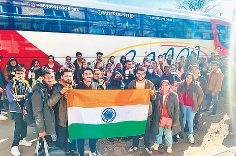 Indian students hold up the National flag as they are escorted from Ukraine to the Romanian border on Friday. (File Photo)