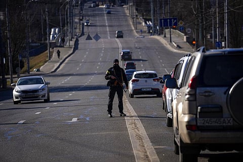 A police officer stands guard at a road leading to central Kyiv, Ukraine, Monday, Feb. 28, 2022. (Photo | AP)