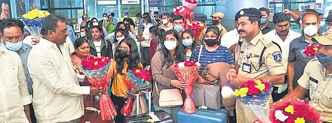 Telangana officials and family members receive students as they arrive at Rajiv Gandhi International Airport in Hyderabad. (Photo| EPS)