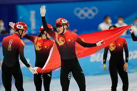 Ren Ziwei of China celebrates with teammates after they won the mixed team relay final during the short track speedskating competition at the 2022 Winter Olympics. (Photo | AP)