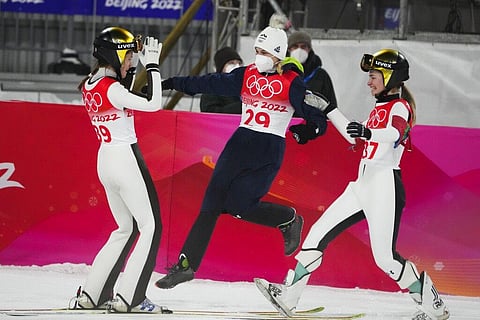 Ursa Bogataj, of Slovenia, left, celebrates with teammates Spela Rogelj, center, Nika Kriznar, after winning gold at the 2022 Winter Olympics. (Photo | AP)