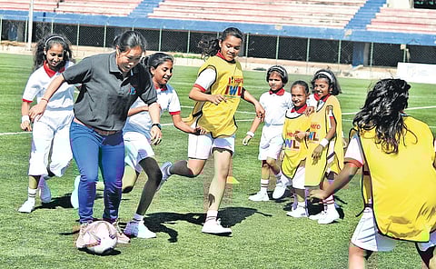 Former Indian women's football team captain Oinam Bembem Devi playing with young girls