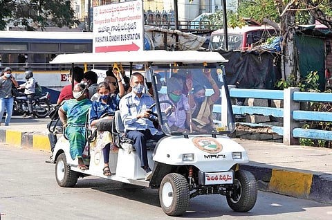 Passengers at the Mahatma Gandhi Bus Station being driven on the electric cart to their respective platforms (Photo| EPS/R V K Rao)