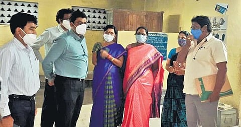 Collector J Nivas inspects a welfare hostel in Penamaluru; a view of renovated hostel toilet in Srikakulam district. (Photo | Express)