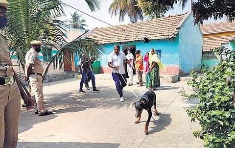 A dog squad and police officials gather evidence near the house where the five members of a family were found murdered in KRS village. (Photo| EPS)
