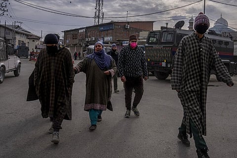 Grieving relatives walk after they were allowed a glimpse of the body of a suspected rebel before being sent to a remote government designated graveyard in Srinagar. (Photo | AP)