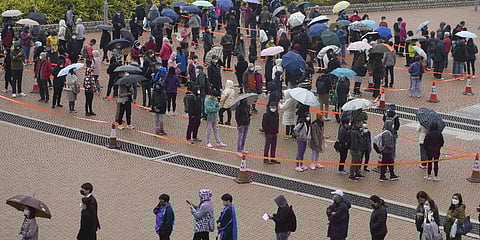 Residents line up to get tested for the coronavirus at a temporary testing center for COVID-19 in Hong Kong Monday, Feb. 7, 2022.(Photo | AP)