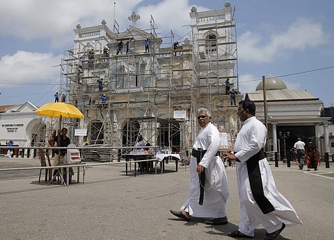 Sri Lankan Catholic priests walk outside the St. Anthony's church after it was partially opened for the first time since the Easter bombings in Colombo. (File Photo | AP)