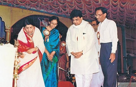 The legendary singer lights the lamp before the beginning of an event