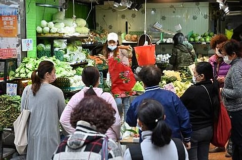Shoppers buy vegetables a day after many shops ran out of some produce in Hong Kong on February 9, 2022. (Photo | AFP)