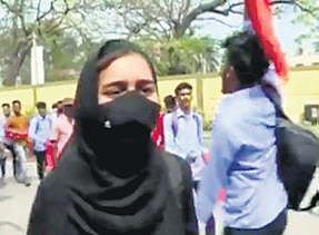 A student wearing a hijab heckled by saffron shawl-clad students in Mandya
