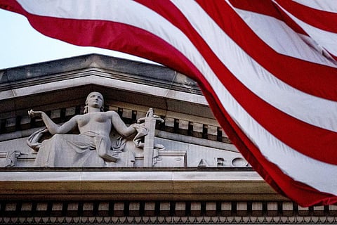 An American flag flies outside the Department of Justice in Washington. (Photo | AP)