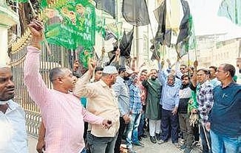 A group of Muslim men stage a protest in front of the Telangana Waqf Board on Tuesday against the demolition of a masjid at Shamirpet on Monday
