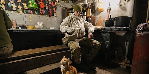 Good luck charms are pinned to a wall as a Ukrainian serviceman pauses in a bunker on a frontline position outside Avdiivka, Donetsk region, eastern Ukraine, Friday, Feb. 4, 2022. (Photo | AP)