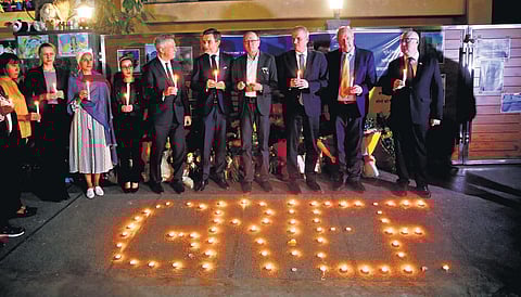 Ukraine envoy Igor Polikha (wearing specs in centre) with foreign diplomats at a candlelight vigil on Monday | SHEKHAR YADAV