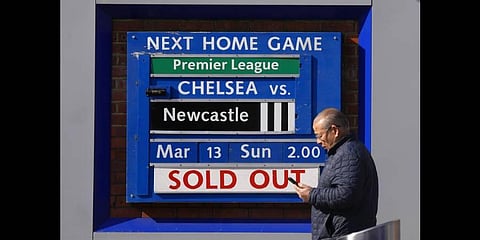 A man passes a match sold out sign at Chelsea football club's Stamford Bridge stadium in London, Thursday, March 10, 2022(Photo | AP)
