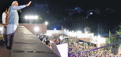 Prime Minister Narendra Modi waves at BJP workers during celebrations at the party headquarters in New Delhi on Thursday. (Photo | PTI)