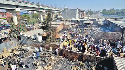 The charred remains of the shanties at Gokulpuri village; (inset) a woman mourns the death of her family members | Shekhar Yadav