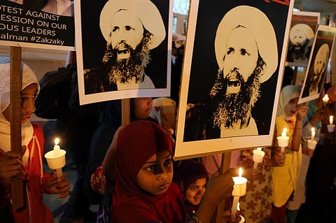 Indian Shiite Muslim children carry portraits of Shiite cleric Sheikh Nimr al-Nimr during a protest against Saudi Arabia in Bangalore, India, 8 January, 2016. (AP Photo)