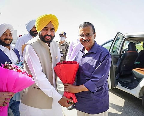 Punjab CM-designate Bhagwant Mann receives AAP national convenor Arvind Kejriwal at Amritsar airport. (Photo | PTI)