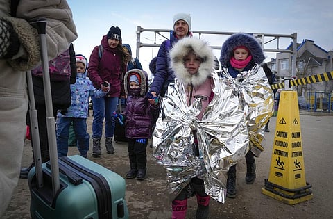 Refugees walk in a group after fleeing the war from neighbouring Ukraine at the border crossing in Palanca, Moldova. (Photo | AP)