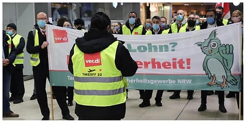 Striking airport staff gather in a terminal in Cologne, Germany, Monday, March 14, 2022. (Photo | AP)