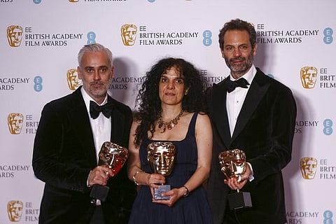 Ian Canning, from left, Tanya Seghatchian, and Emile Sherman hold the Best Film award on behalf of Jane Campion for the film 'Power of the Dog'(Photo | AP)