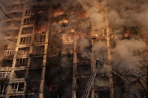 Firefighters extinguish fires in an apartment building after being hit by shelling in Kyiv, Ukraine. ( Photo | AP)