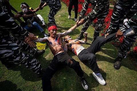 Indian policemen detain exile Tibetans during a protest outside the Chinese Embassy, in New Delhi. ( Photo | AP)
